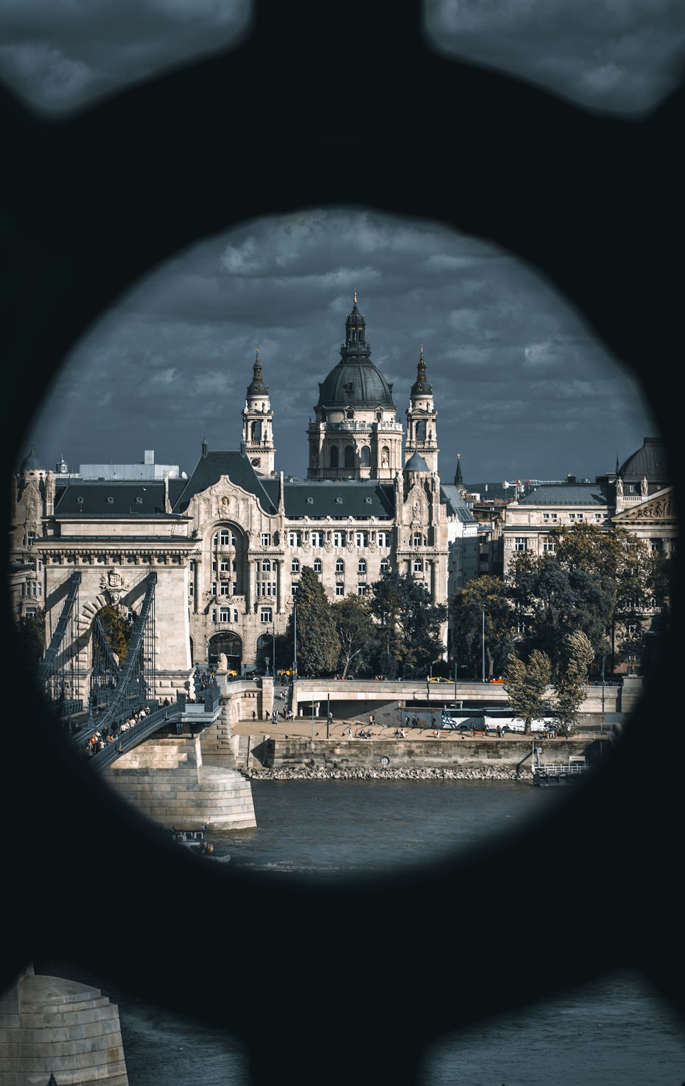 a view of a large building through a hole in a fence