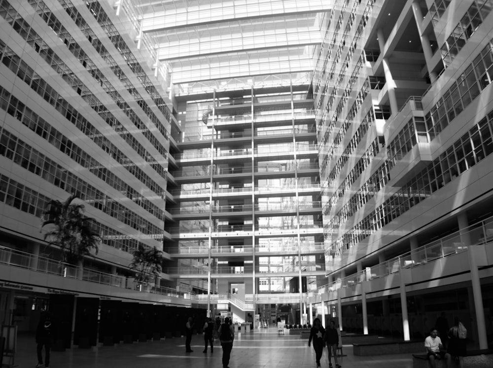 a group of people walking through a large building