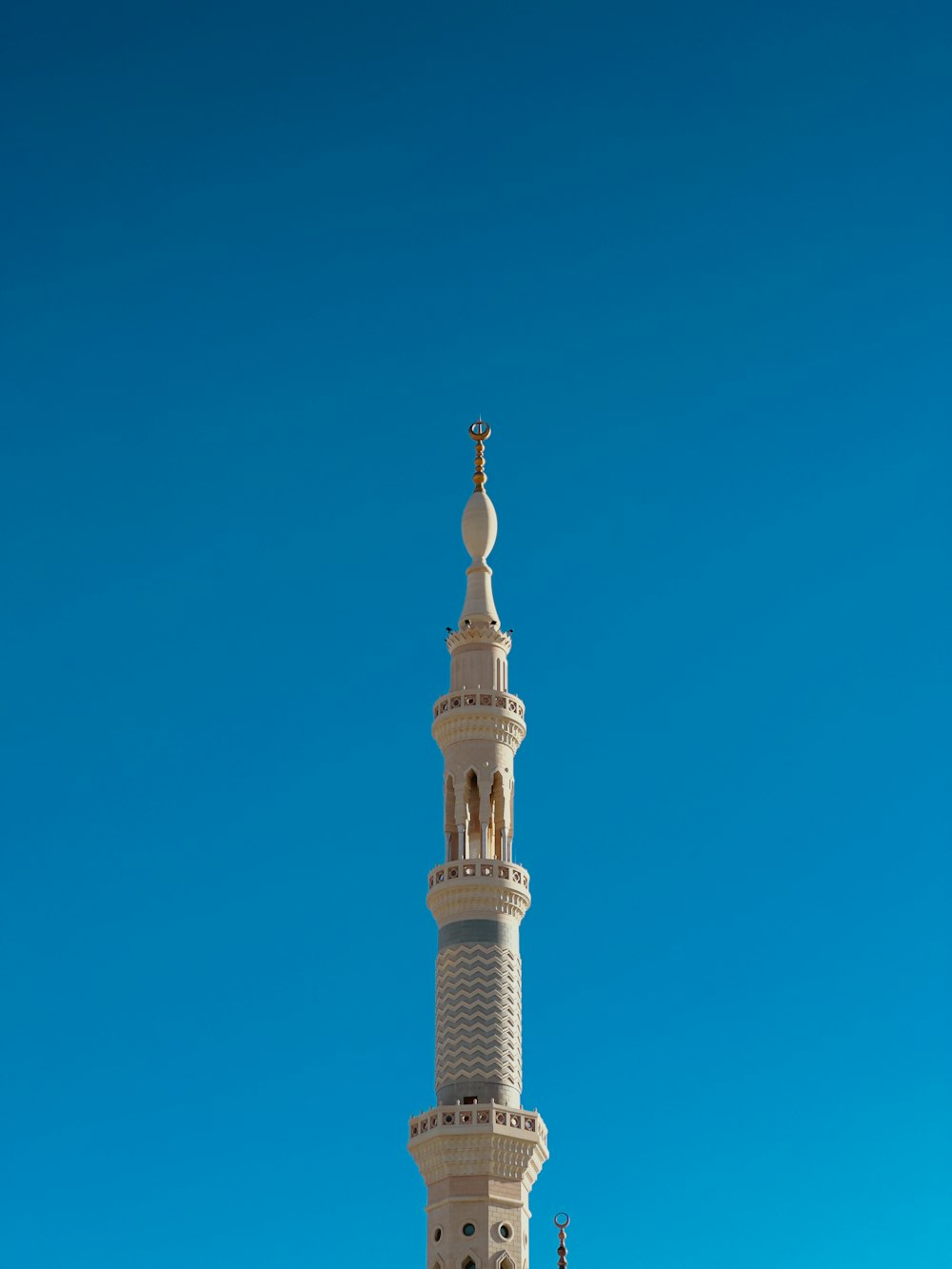 a tall white building with a cross on top