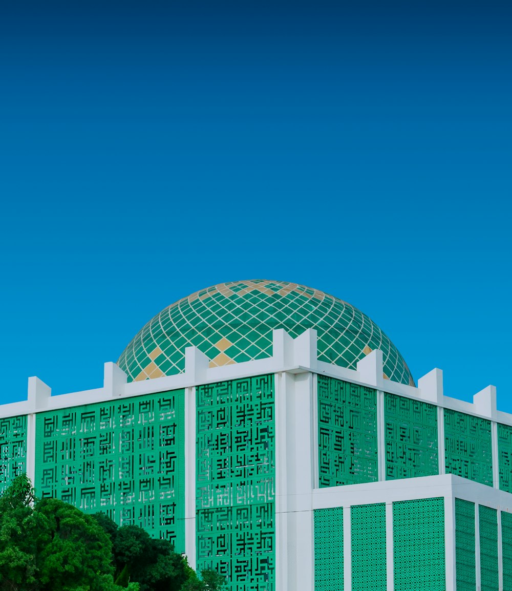 a large building with a green dome on top of it