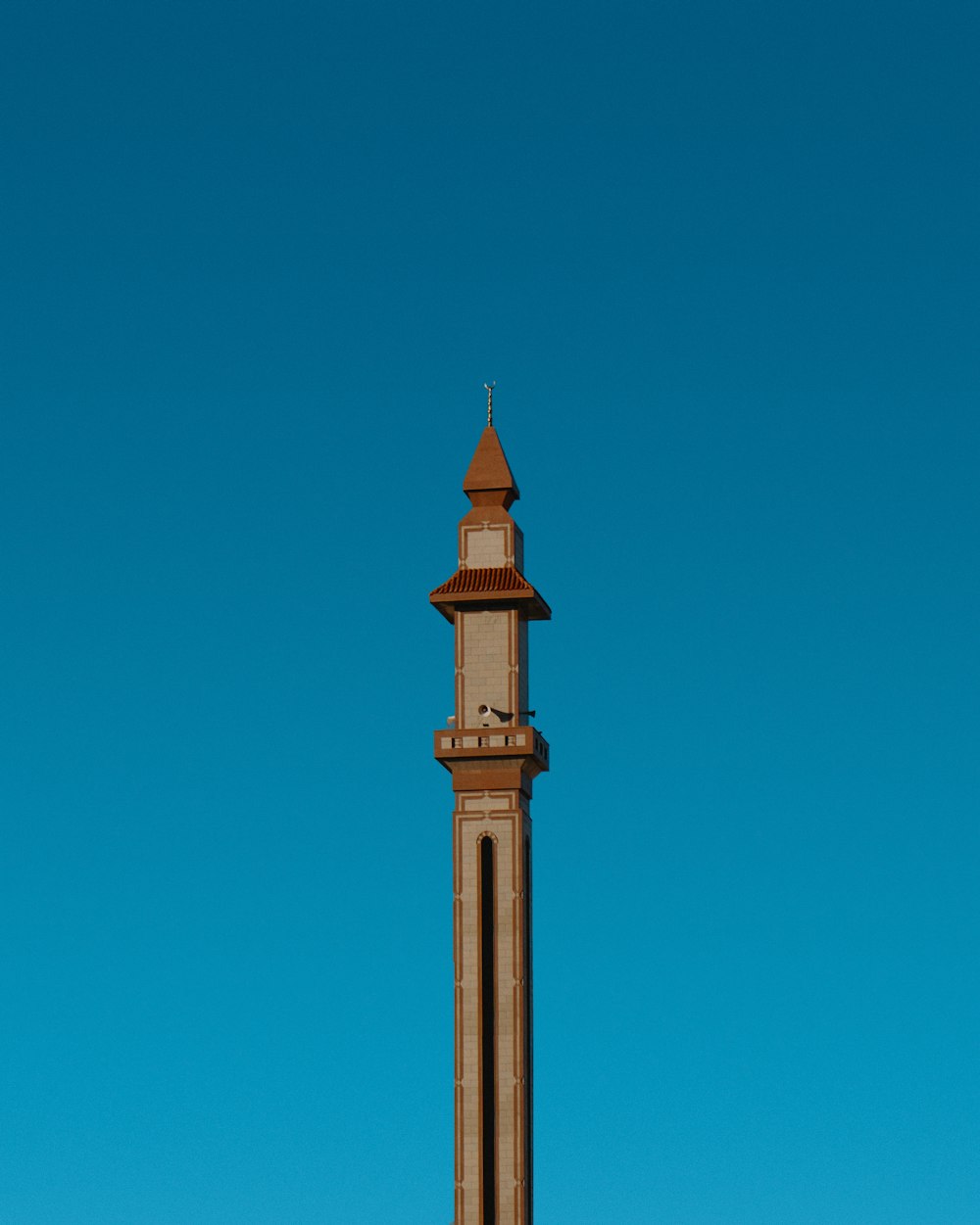 a tall tower with a clock on the top of it