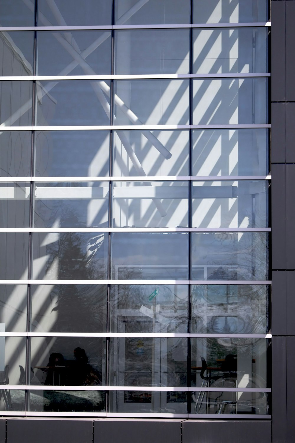 a large window with a reflection of a building