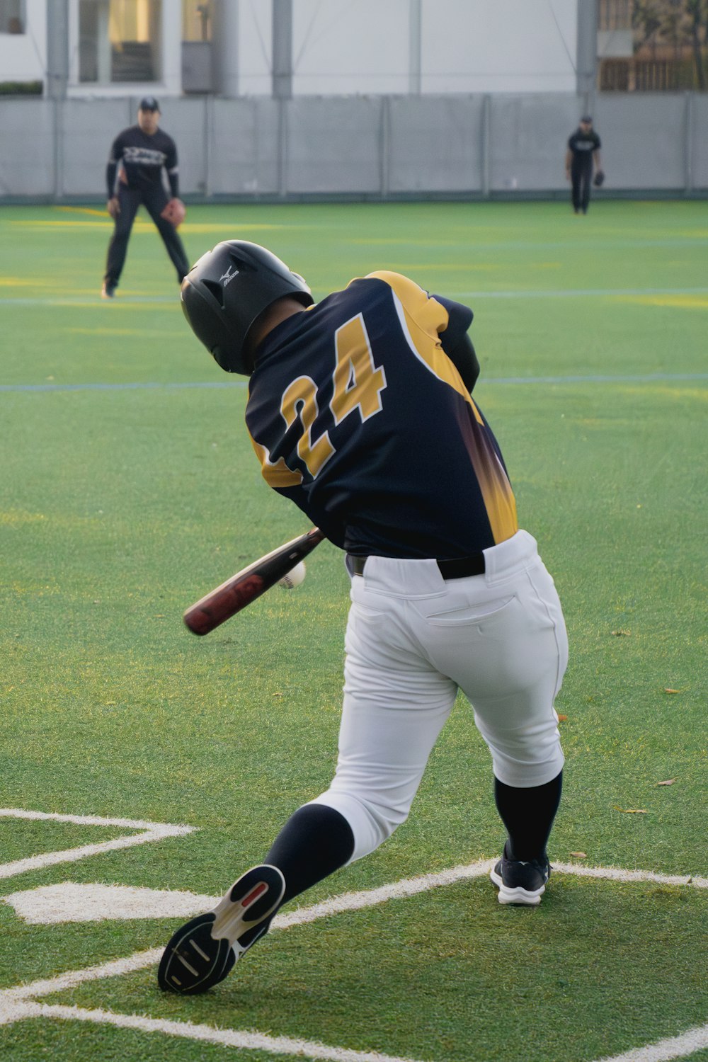 a baseball player swinging a bat on a field