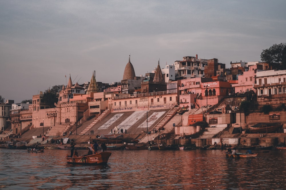 a group of people in a small boat on a body of water