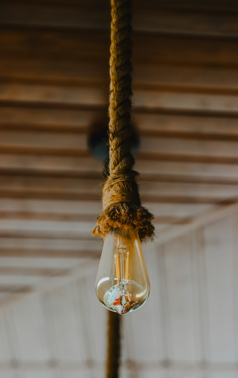 a light bulb hanging from a rope in a room