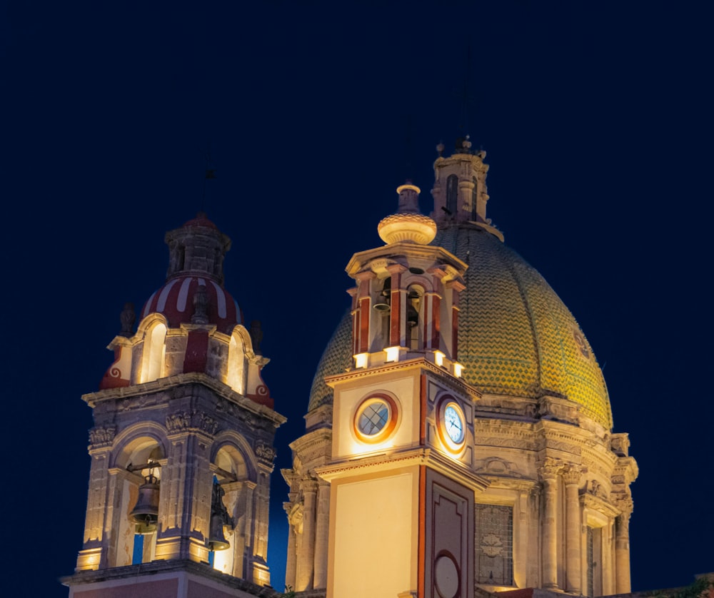 a large building with a clock tower at night