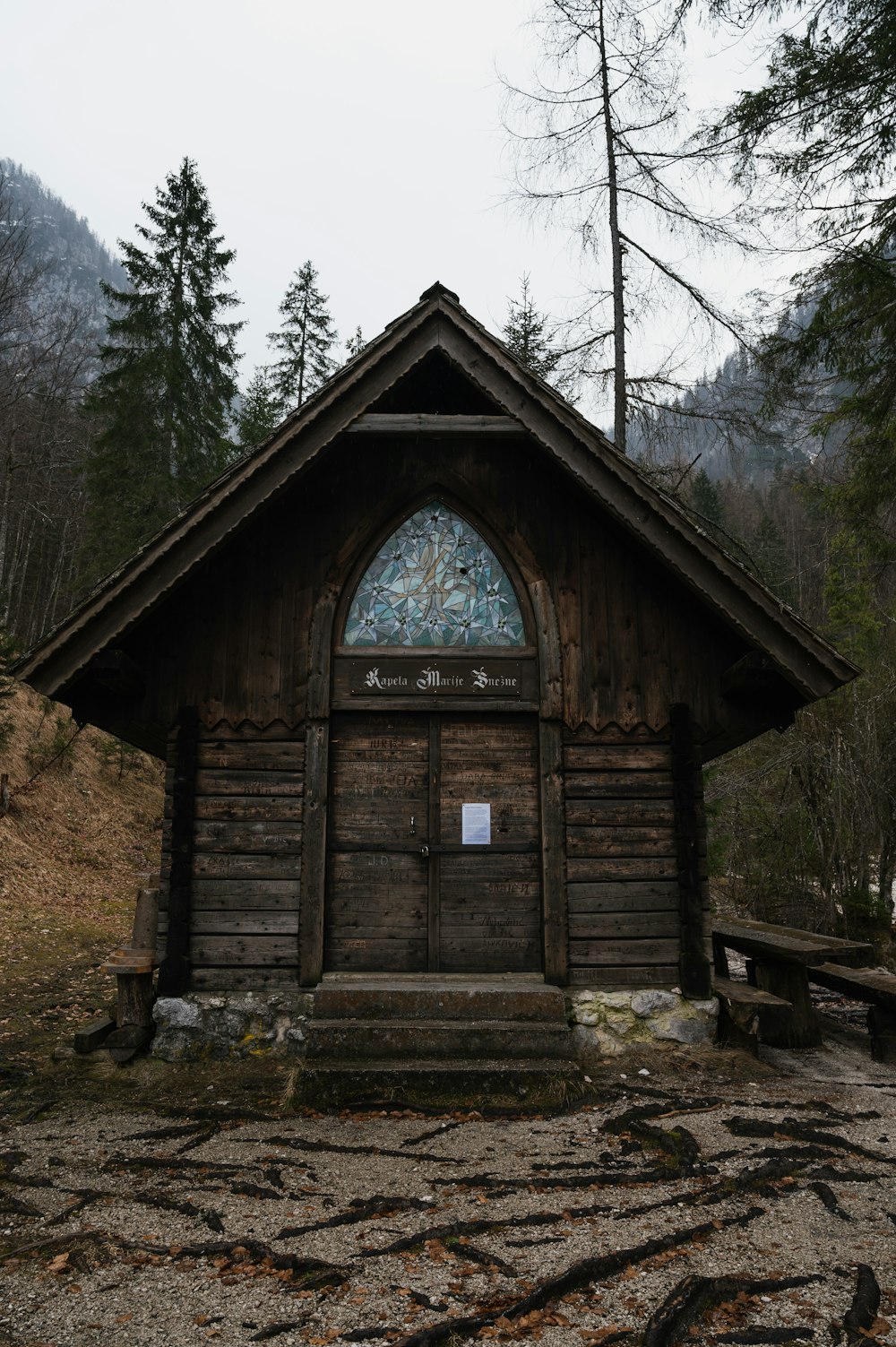 a small wooden building with a stained glass window