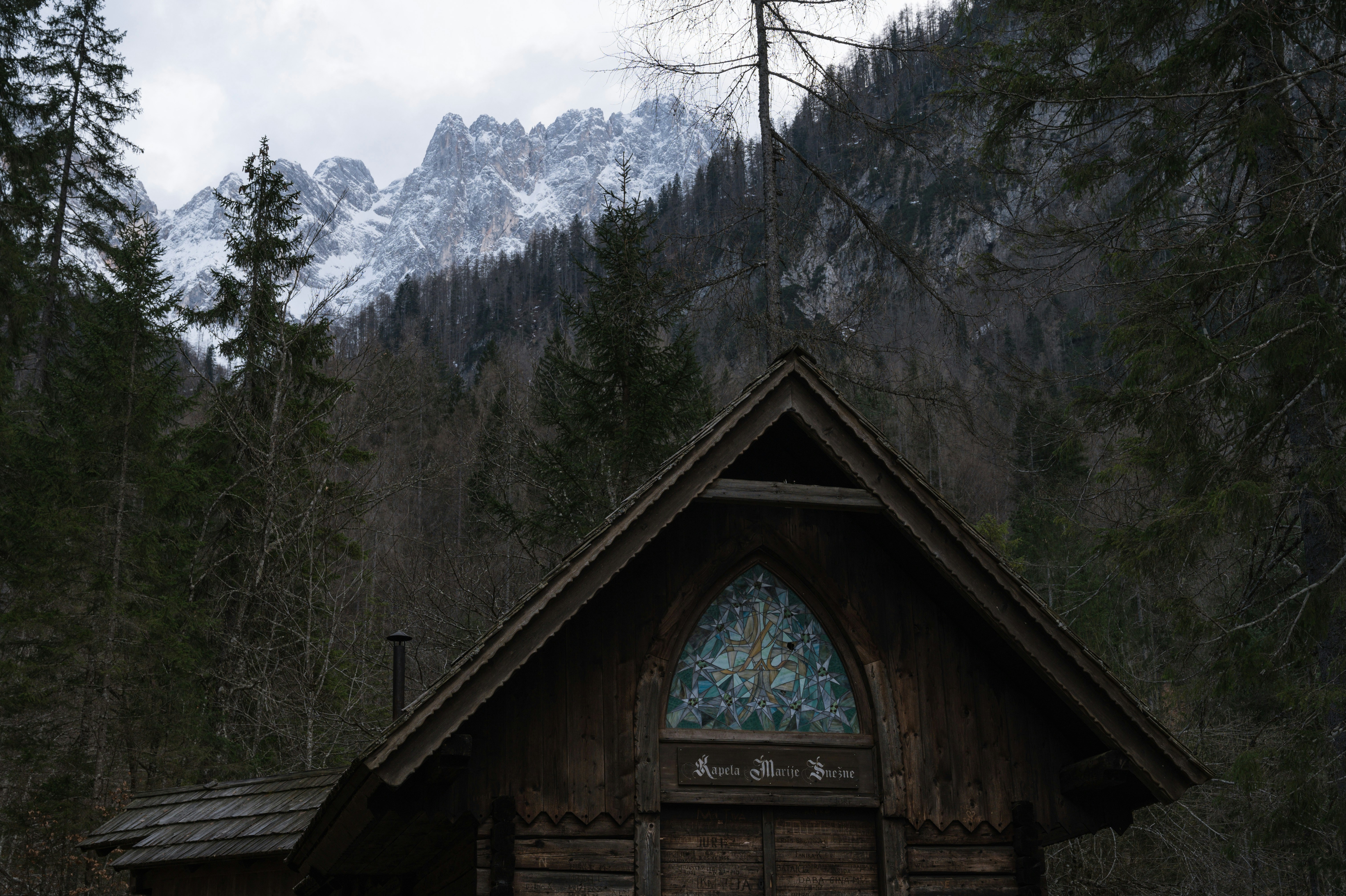 a small wooden building with a stained glass window