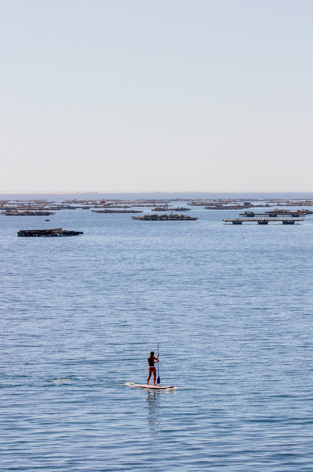 a person riding a paddle board on a body of water