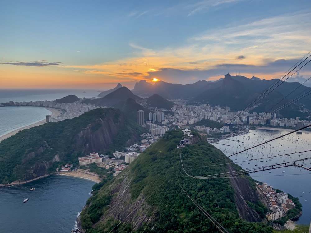 the sun is setting over the city of rio