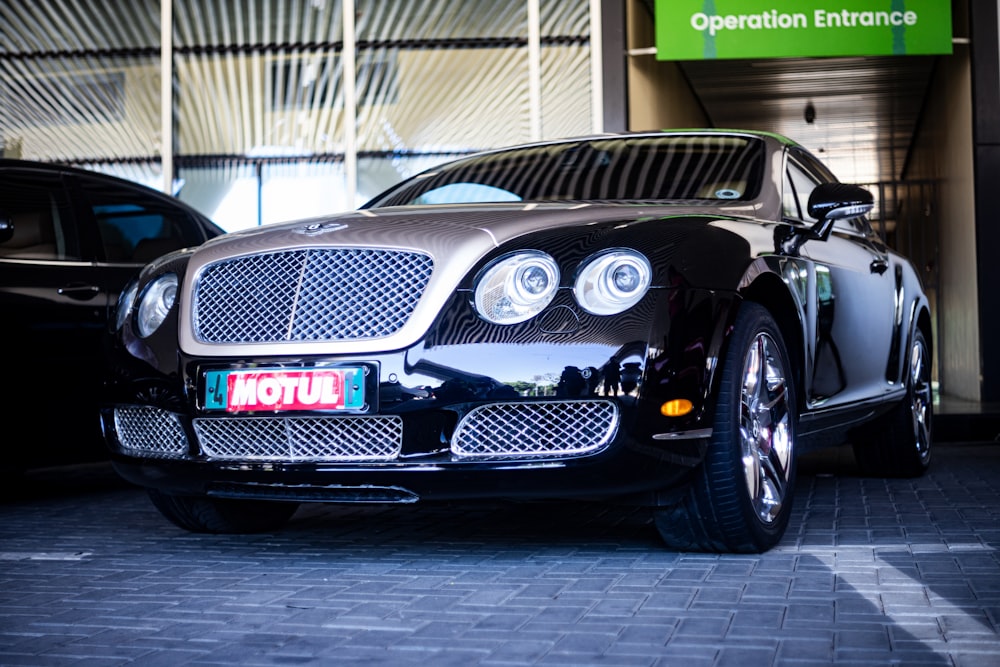 a black car parked in front of a building