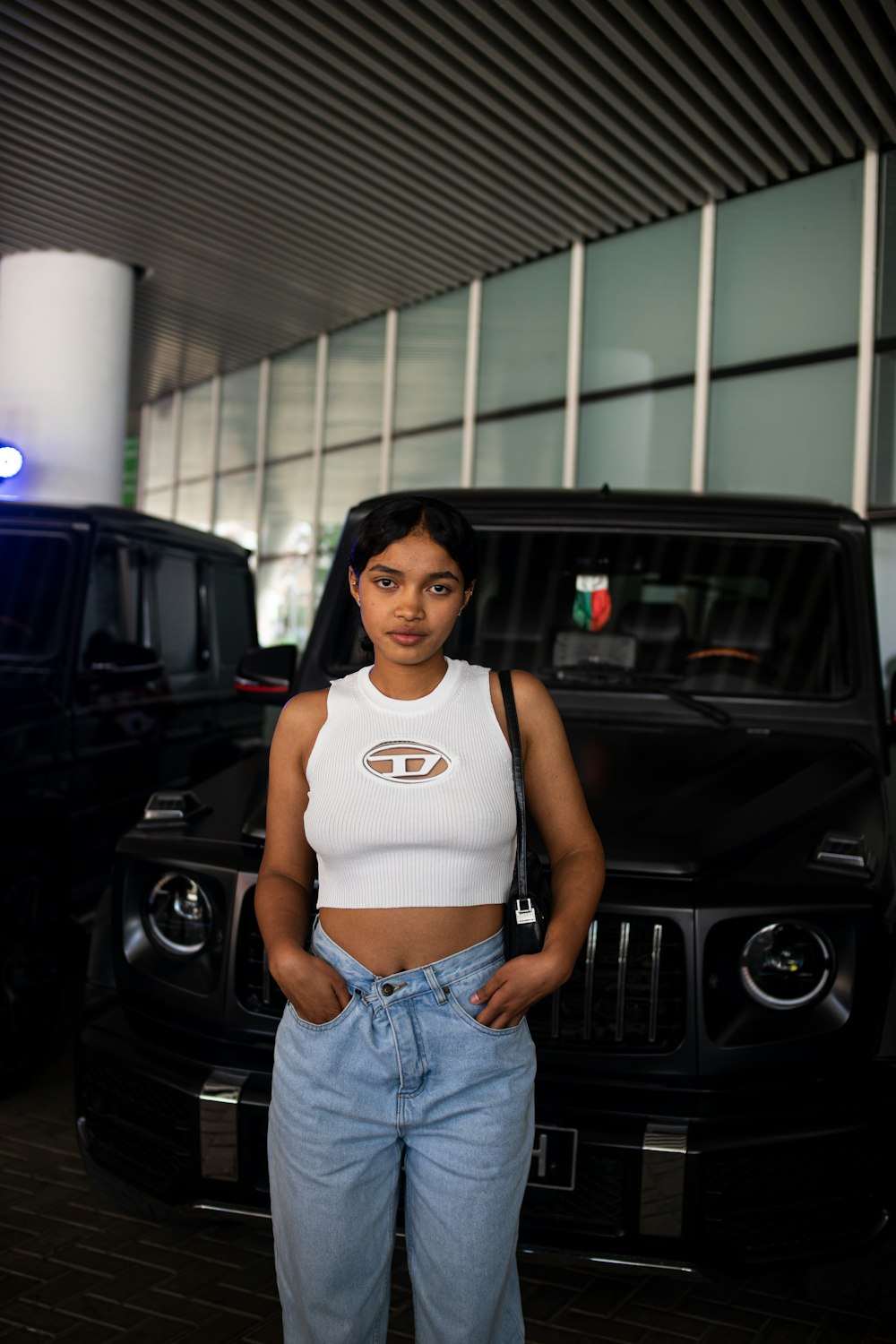 a woman standing in front of a black truck