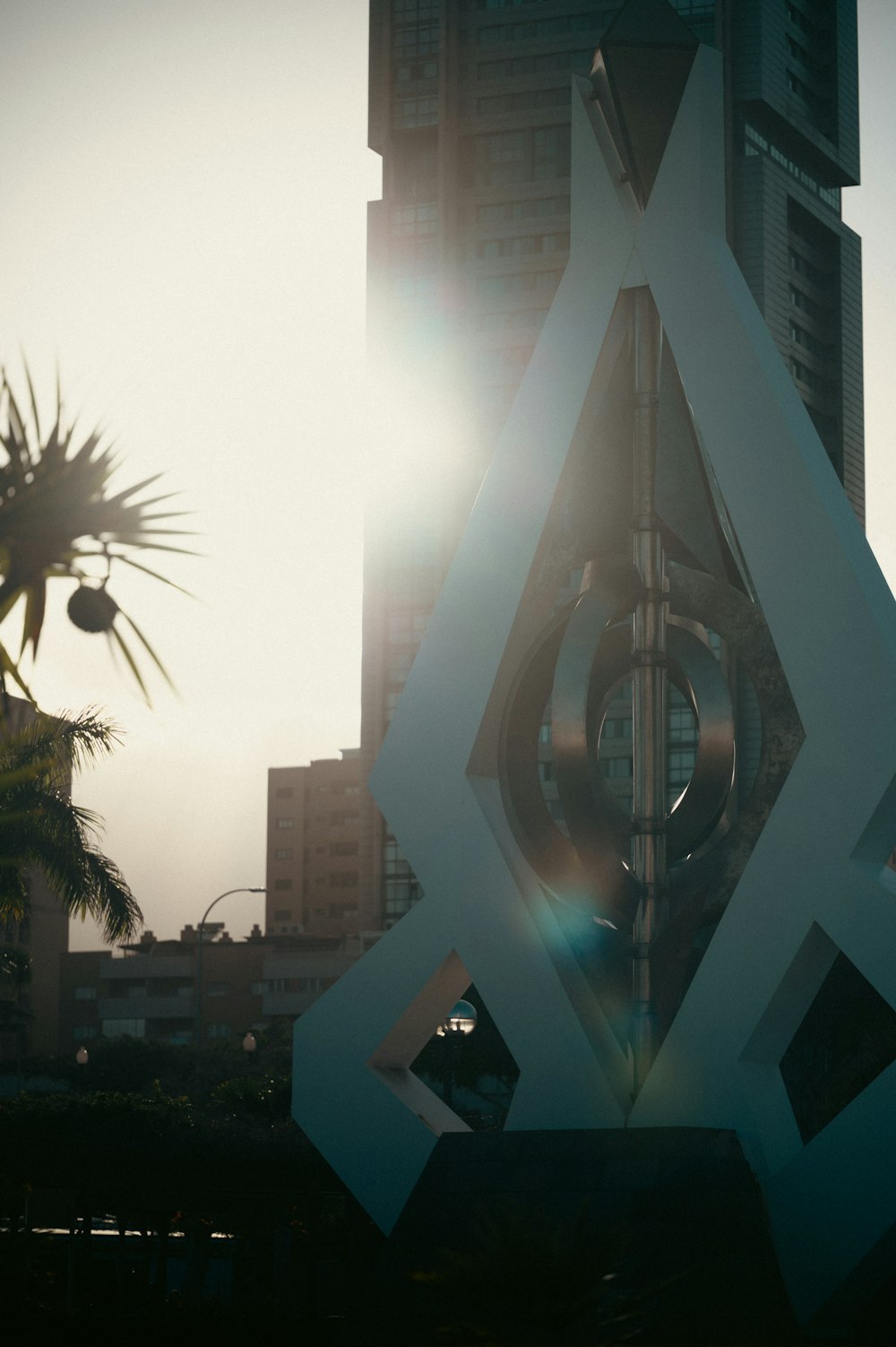 a large white sculpture in front of a tall building