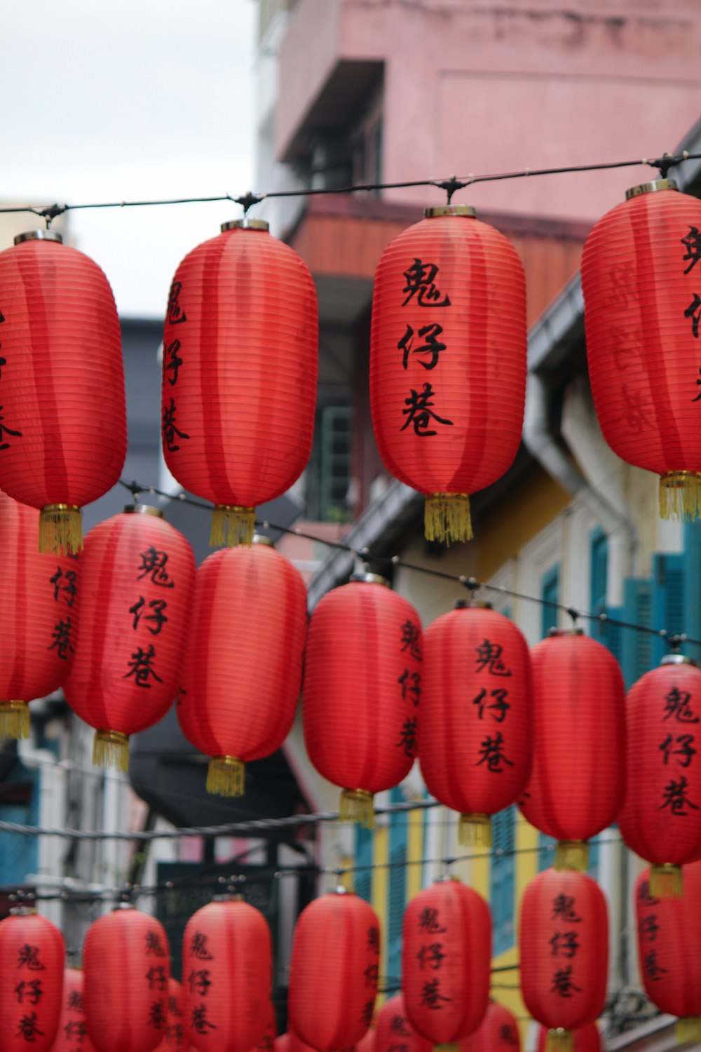 a bunch of red lanterns hanging from a line