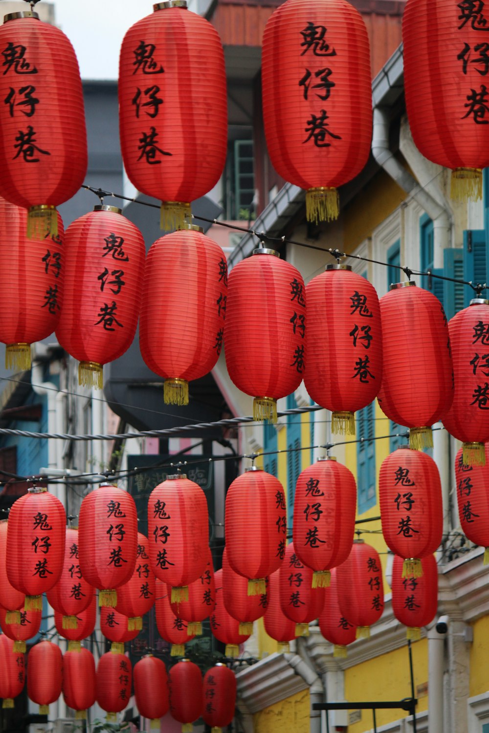 a bunch of red lanterns hanging from a line