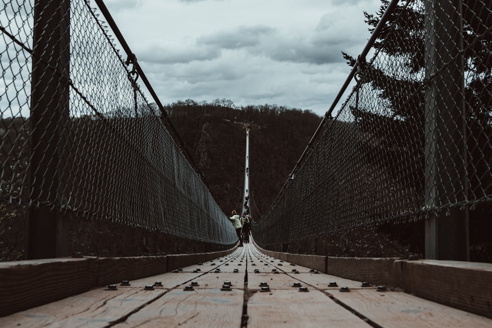 a person standing on a bridge over a river