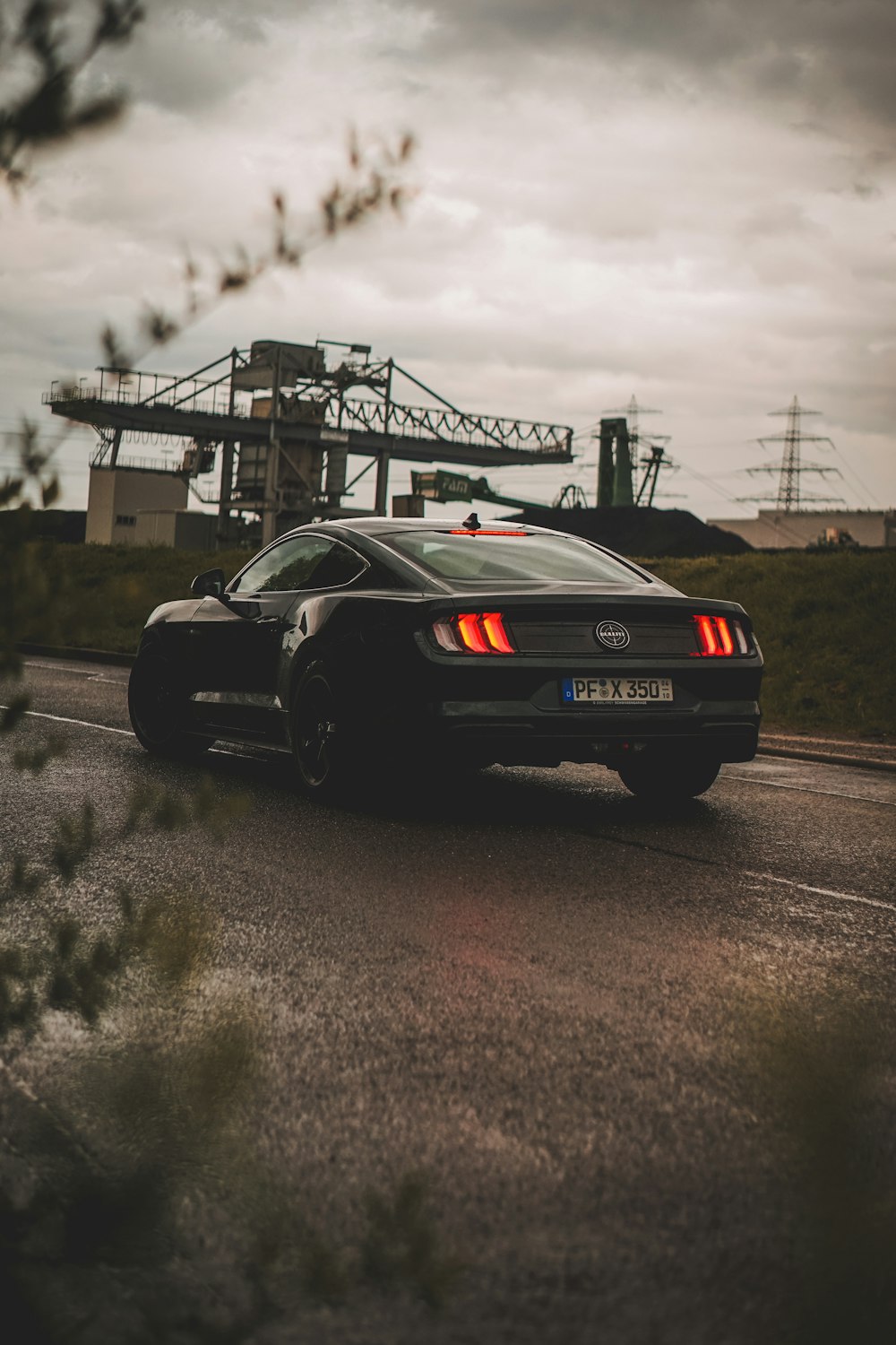 a black sports car driving down a road