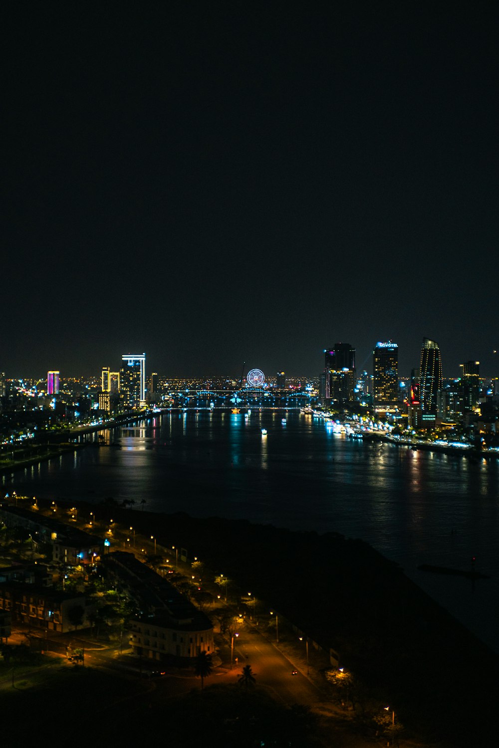 a view of a city at night from the top of a hill