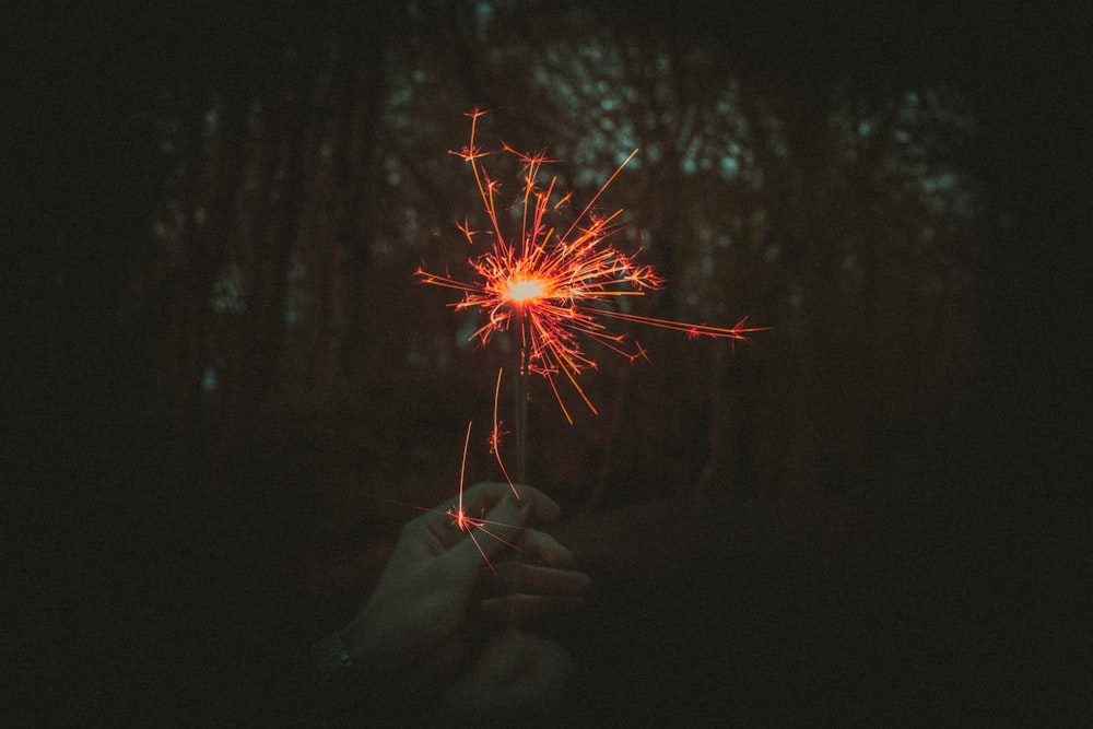 a person holding a sparkler in their hand