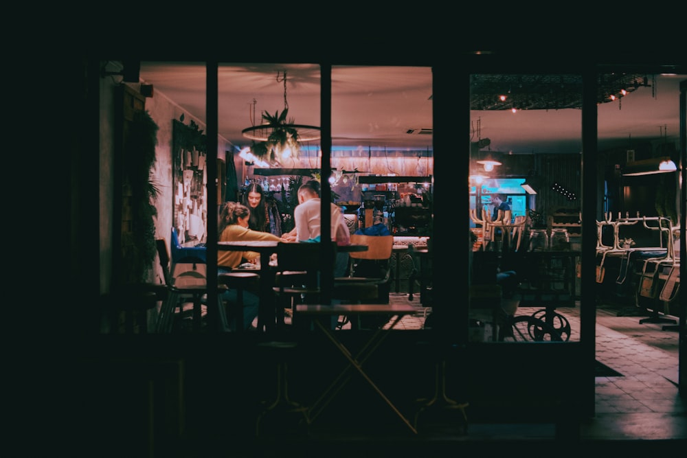 a couple of people sitting at a table in a room