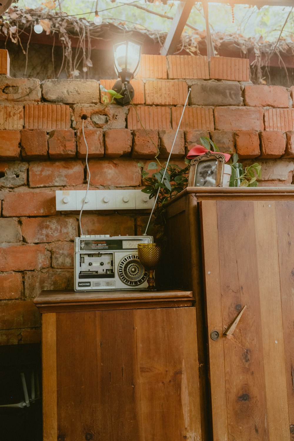 a radio sitting on top of a wooden cabinet