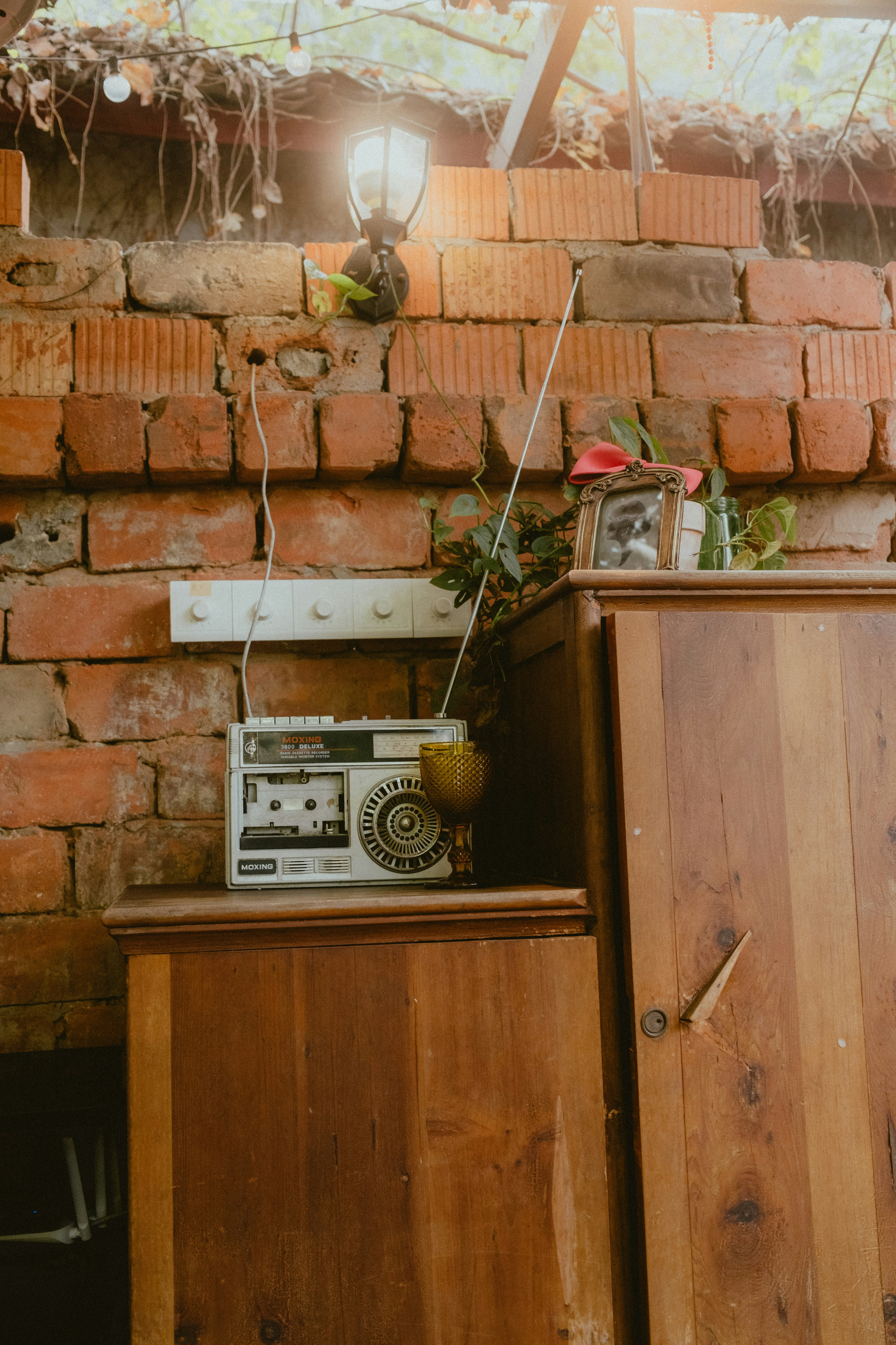 a radio sitting on top of a wooden cabinet