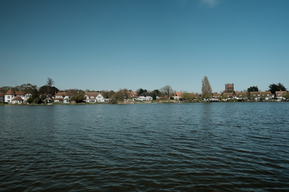 a body of water with houses in the background