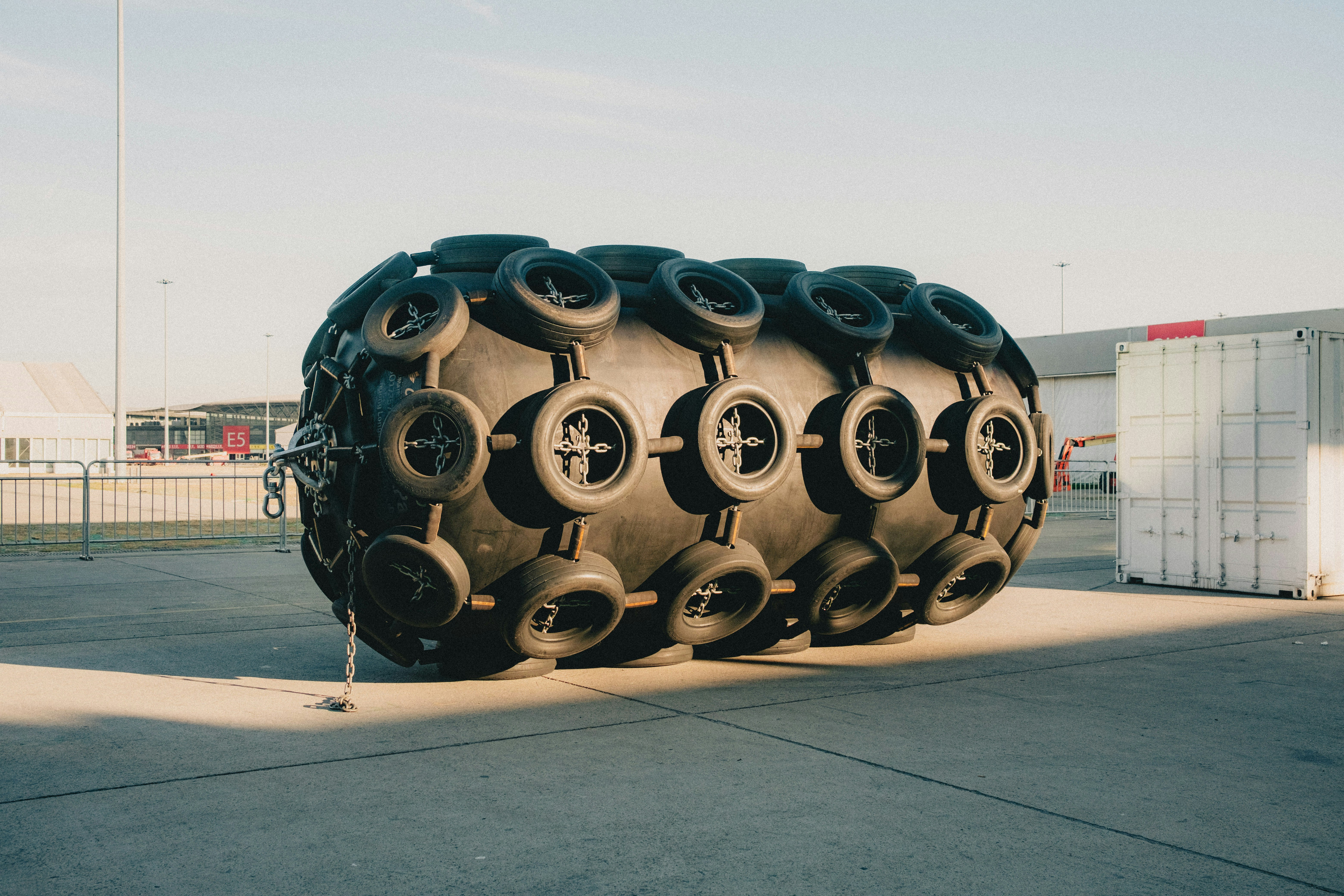 a large pile of tires sitting on top of a tarmac