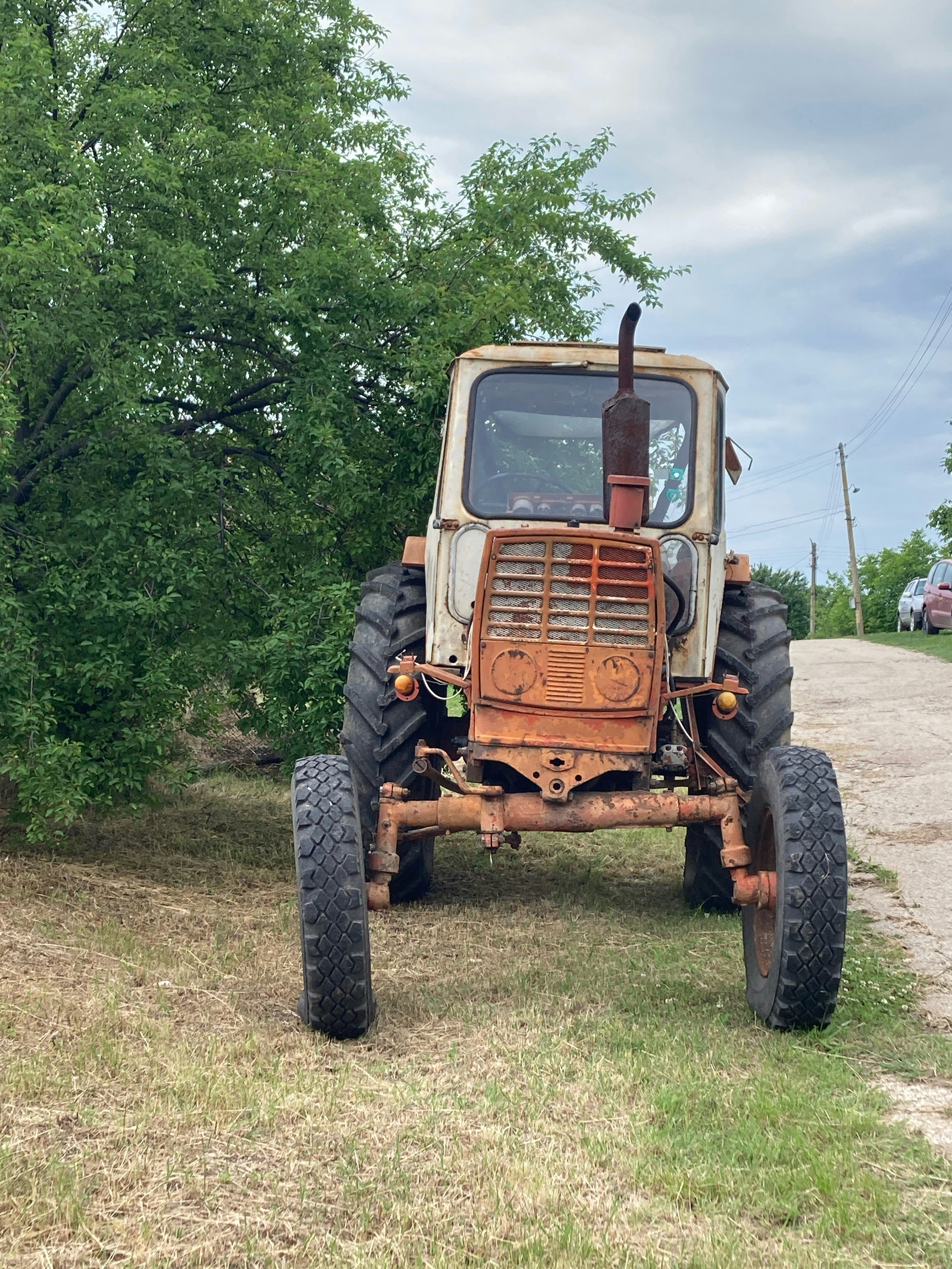 an old tractor sitting in the middle of a field