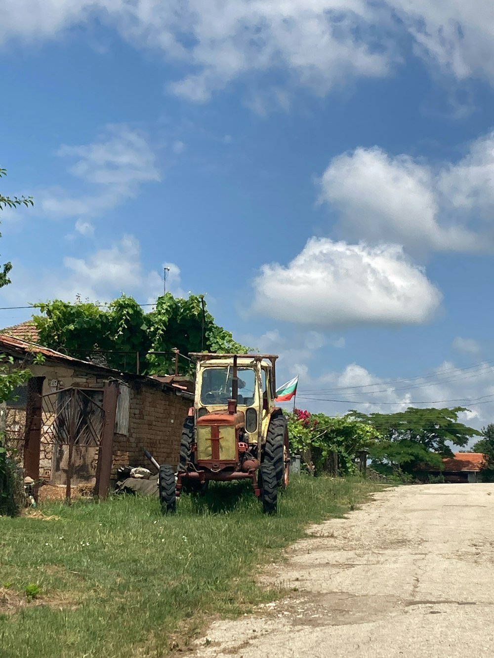 a tractor parked on the side of a dirt road