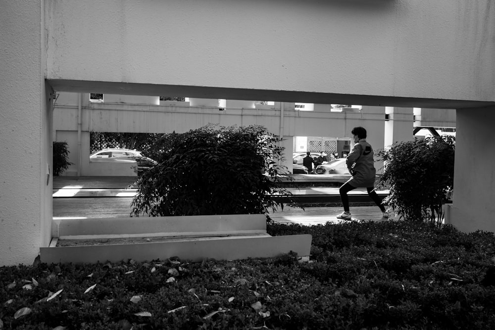 a black and white photo of a person walking