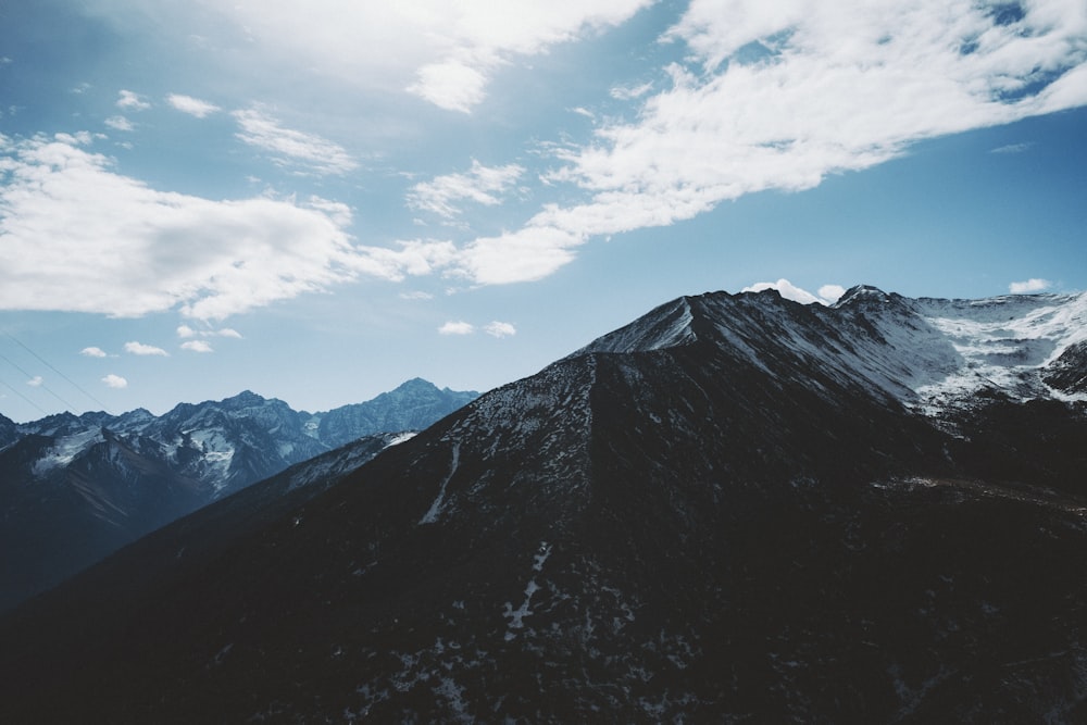 a view of the top of a mountain with a sky background