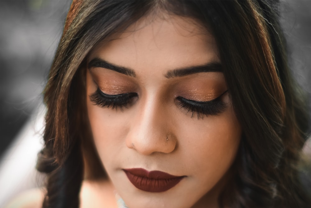 a close up of a woman with dark makeup