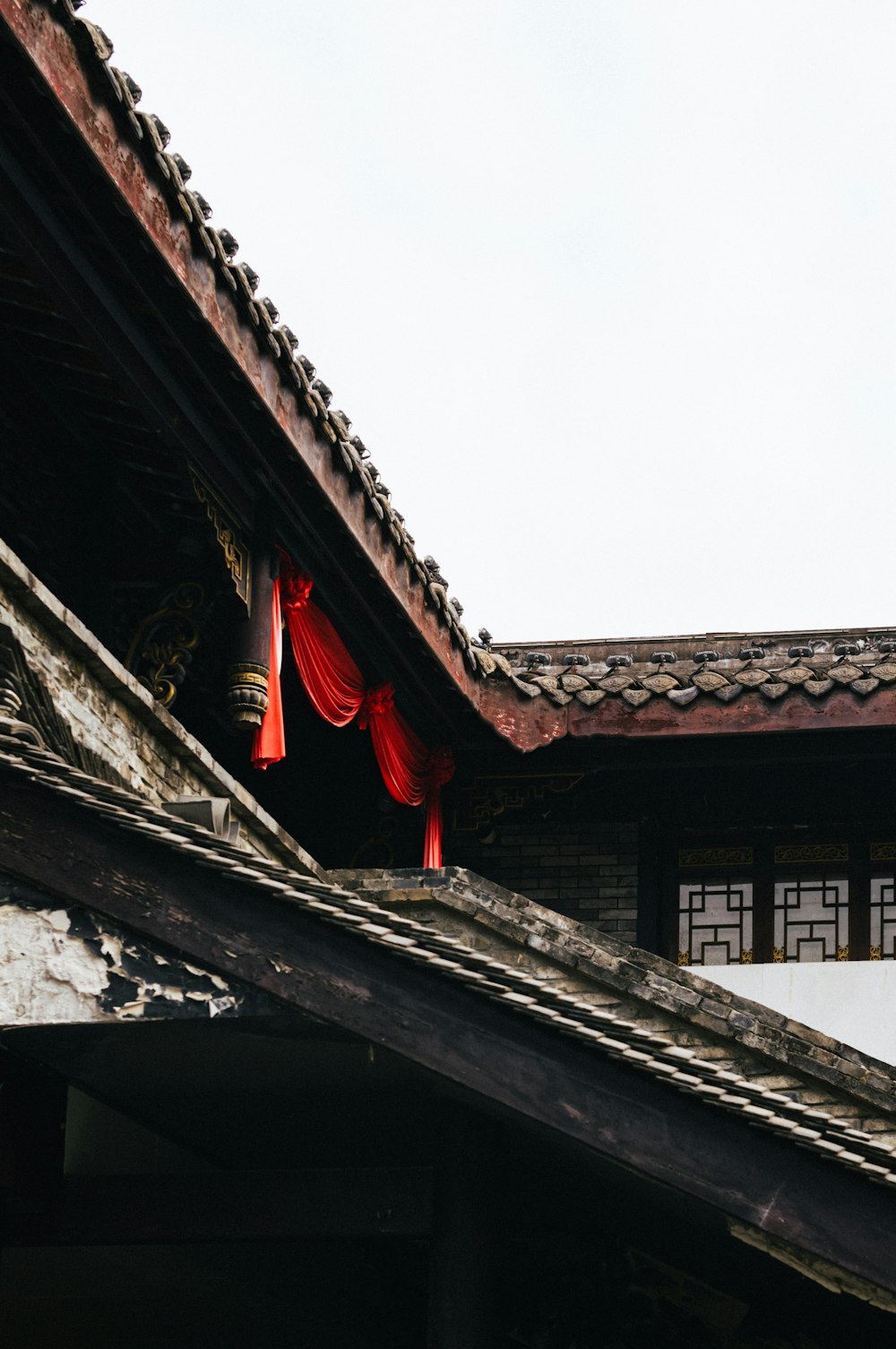 a building with red curtains hanging from it's roof