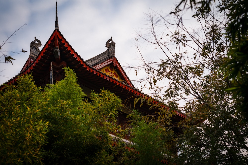 a building with a red roof surrounded by trees