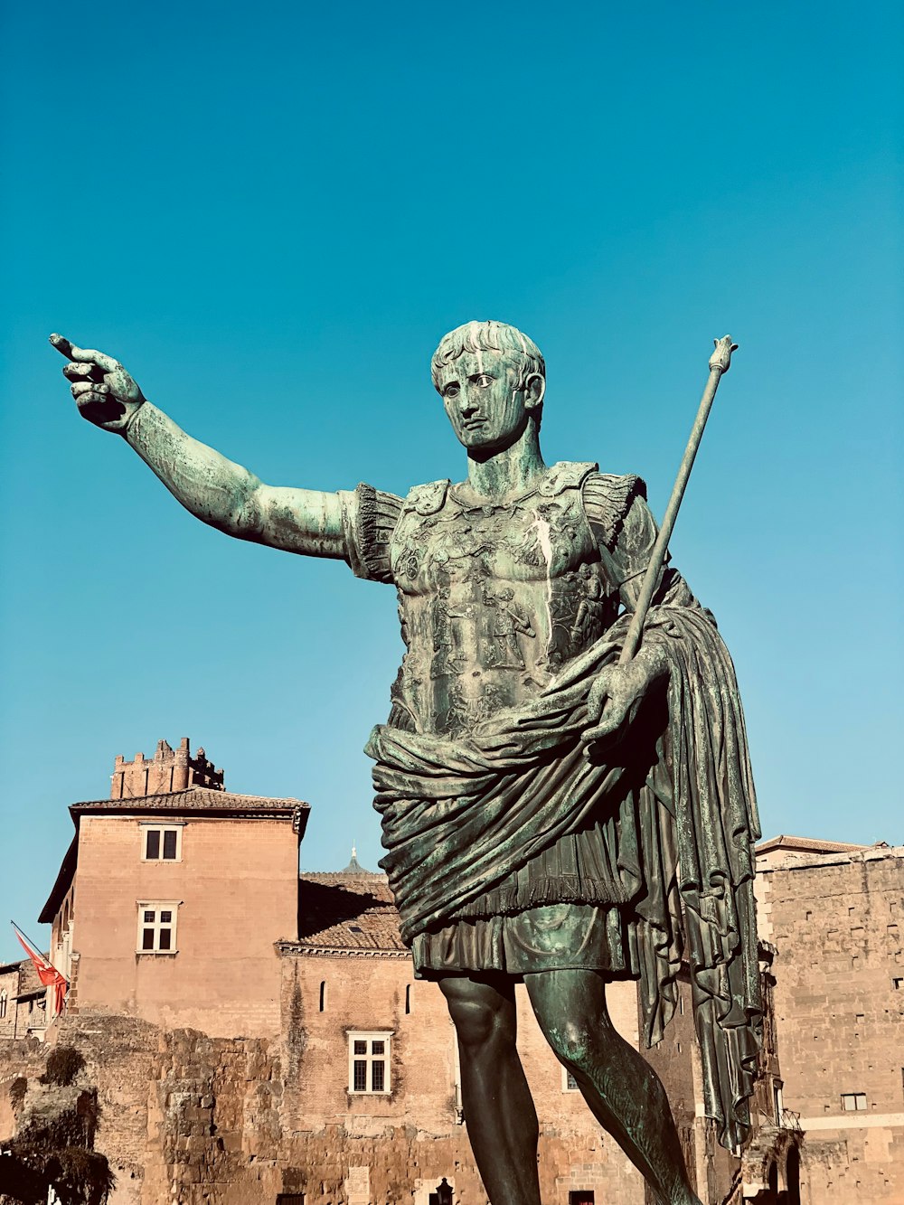 a statue of a man holding a staff