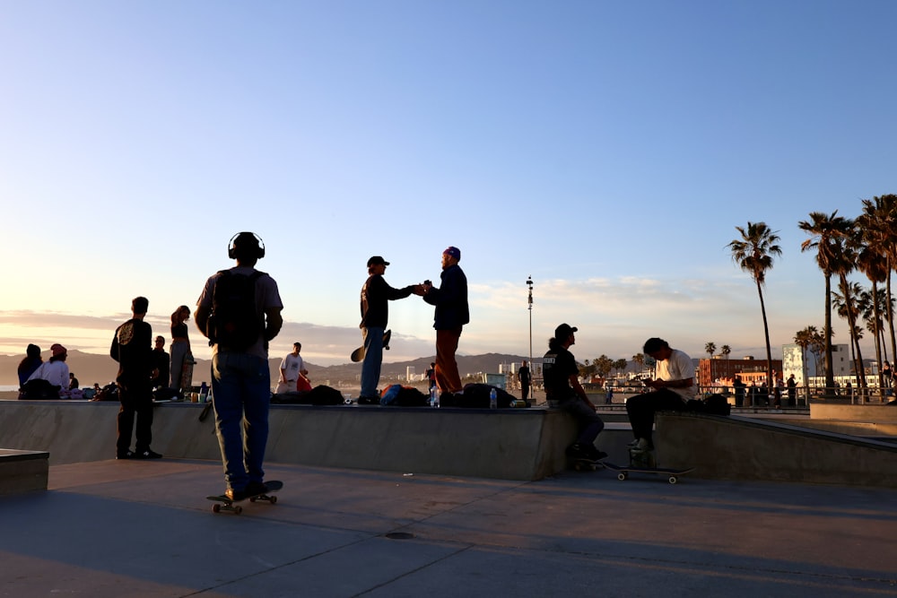 a group of people standing around a skateboard park
