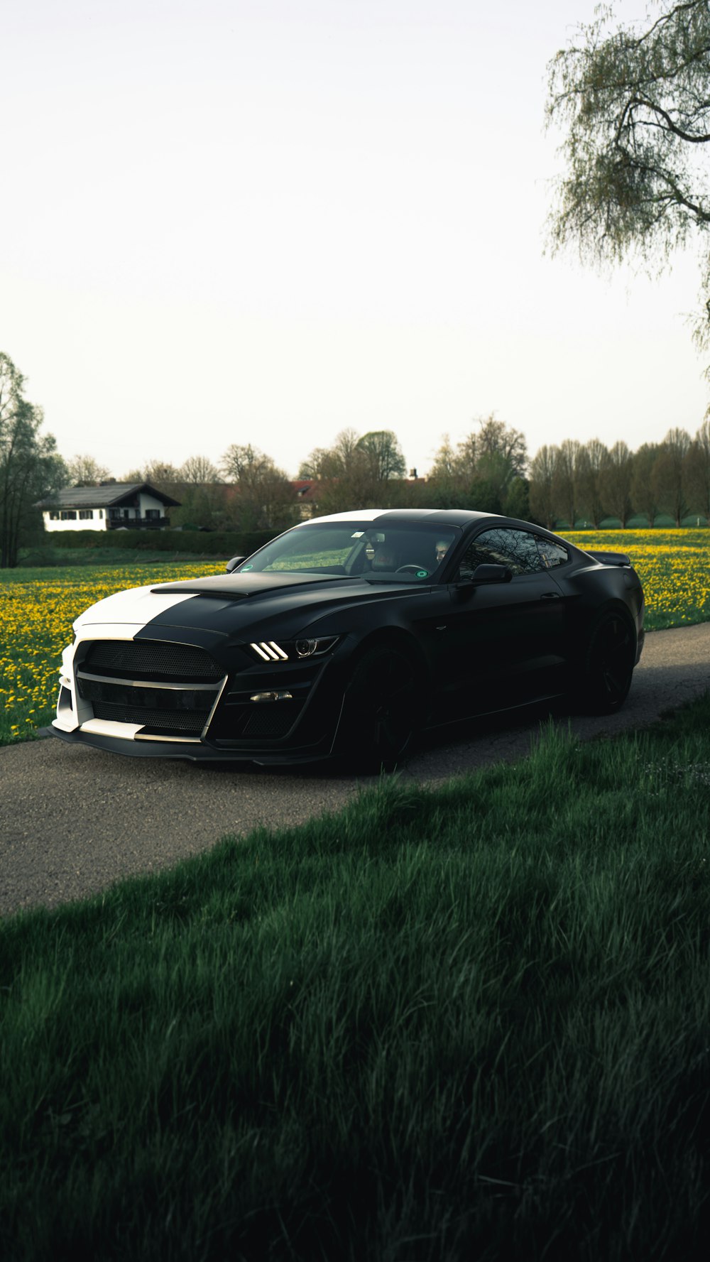 a black sports car parked on the side of a road