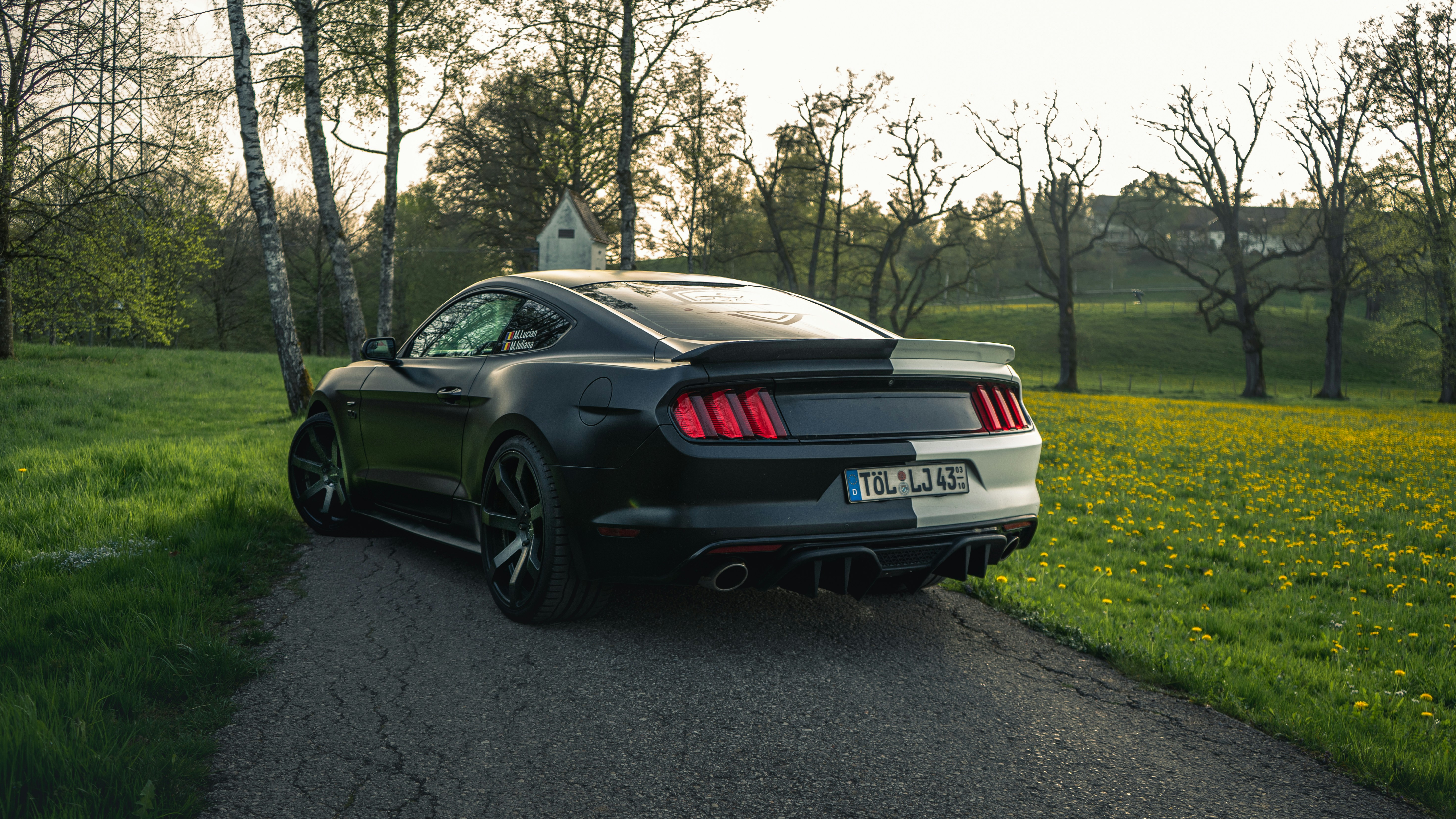a black sports car parked on the side of a road