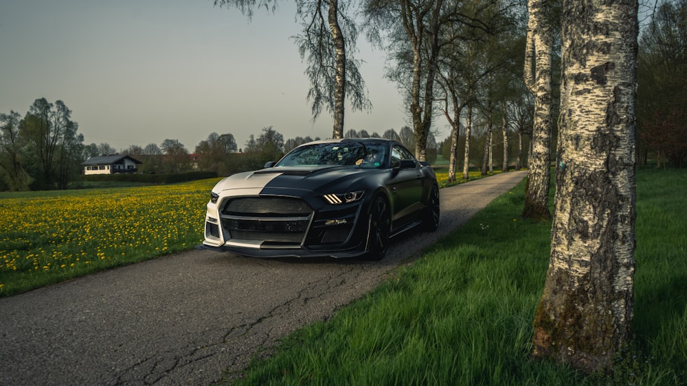 a black sports car parked on the side of a road