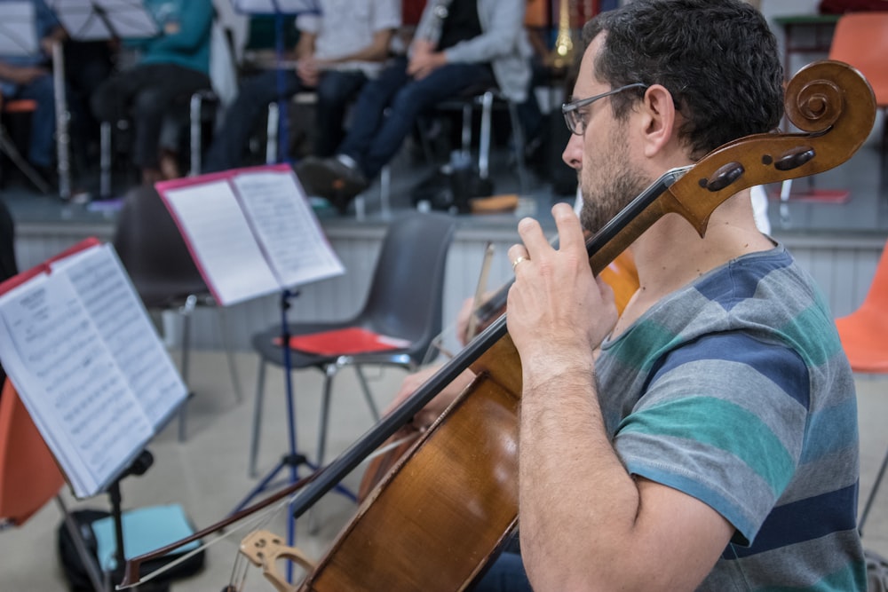 a man playing a violin in front of a group of people