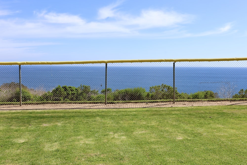 a baseball field with a view of the ocean