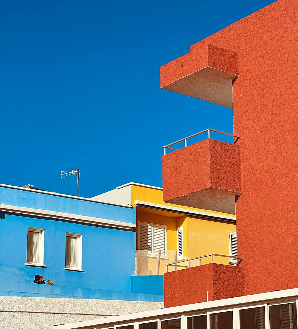 a tall building with balconies on the top of it