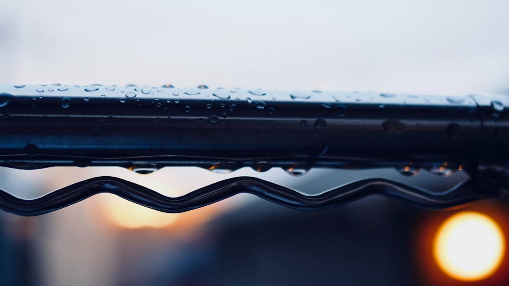 a close up of a roof with rain drops
