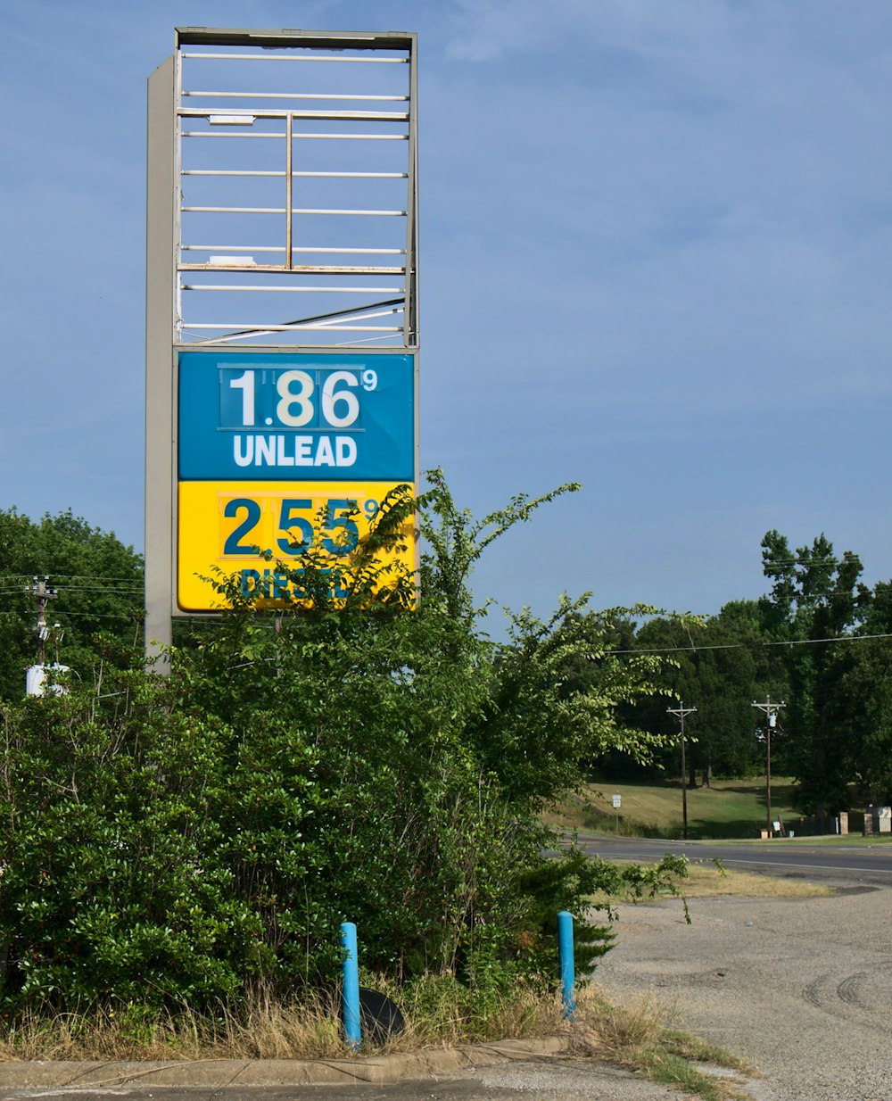 a sign for a gas station in a rural area