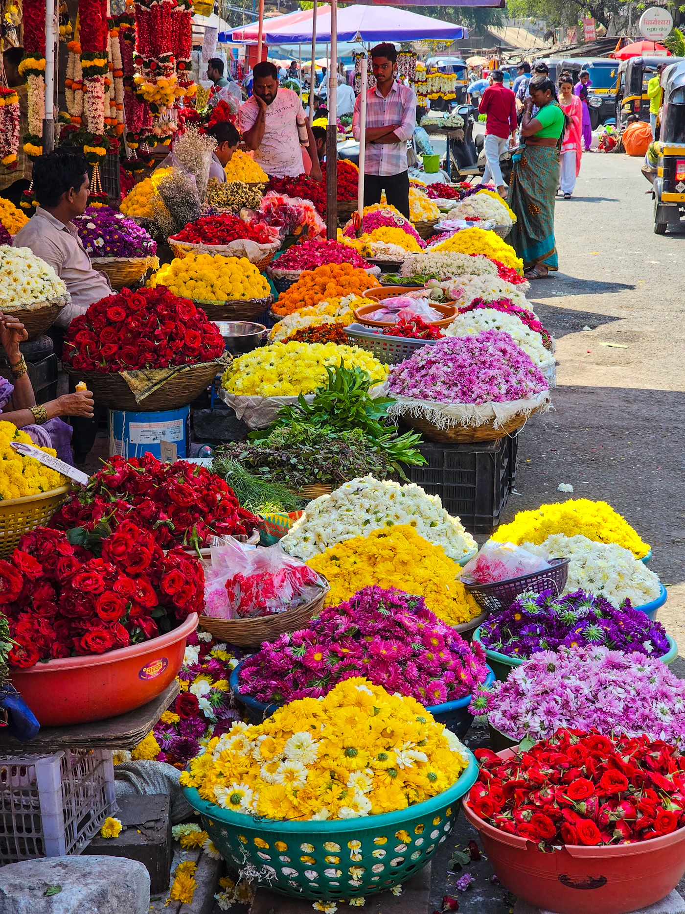 Wicker baskets of fresh flowers arranged at a market stall