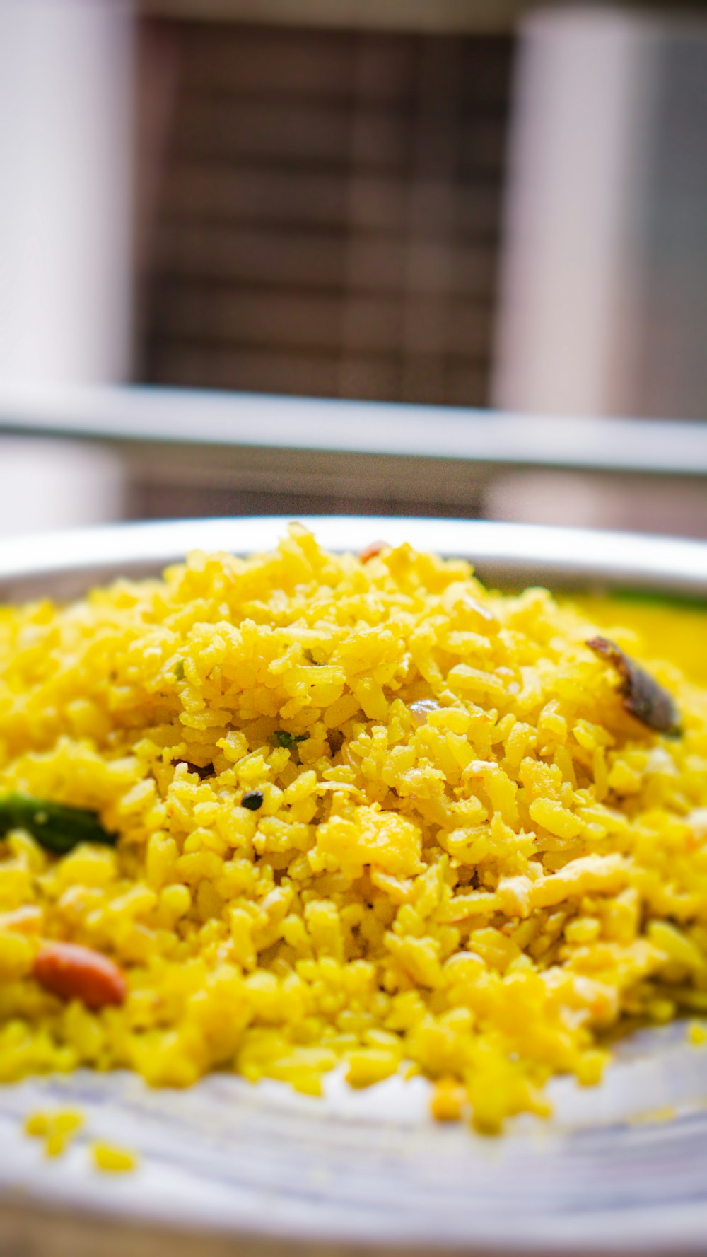 a white plate topped with yellow rice and vegetables