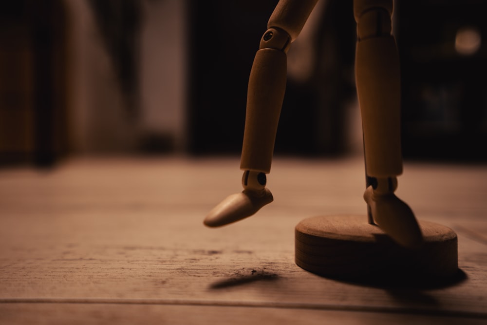 a wooden toy standing on top of a wooden floor