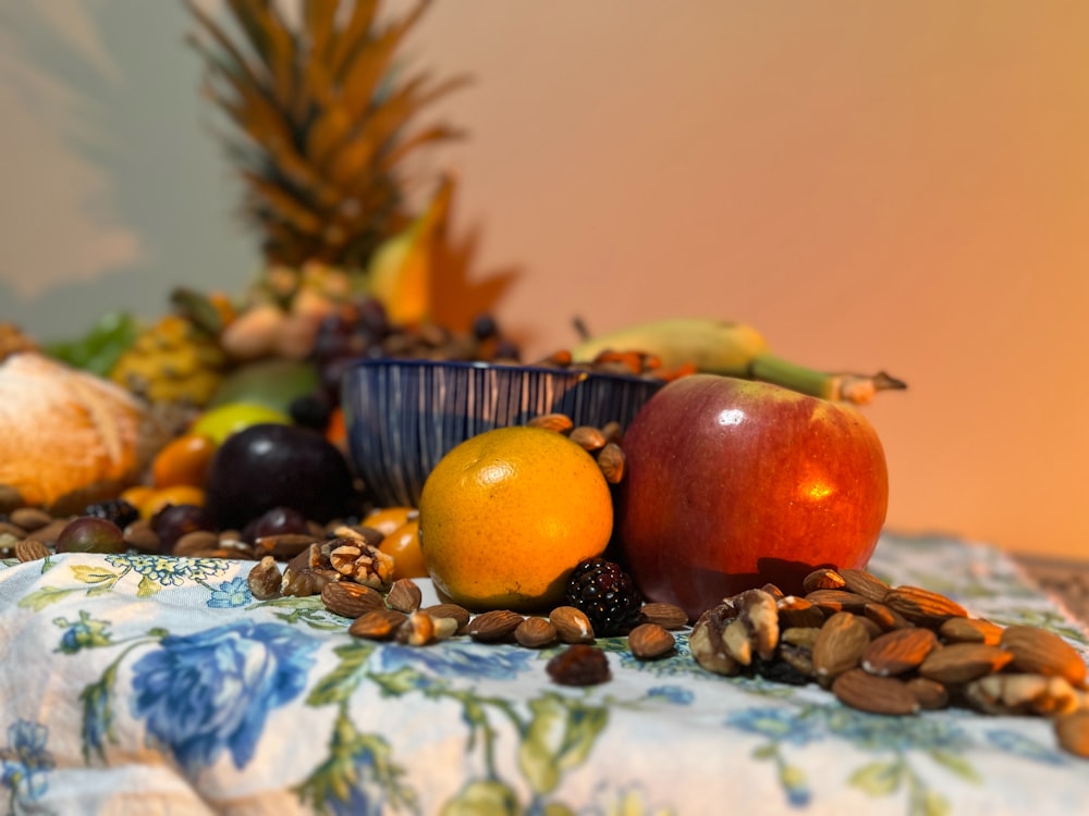 a table topped with a bowl of fruit and nuts