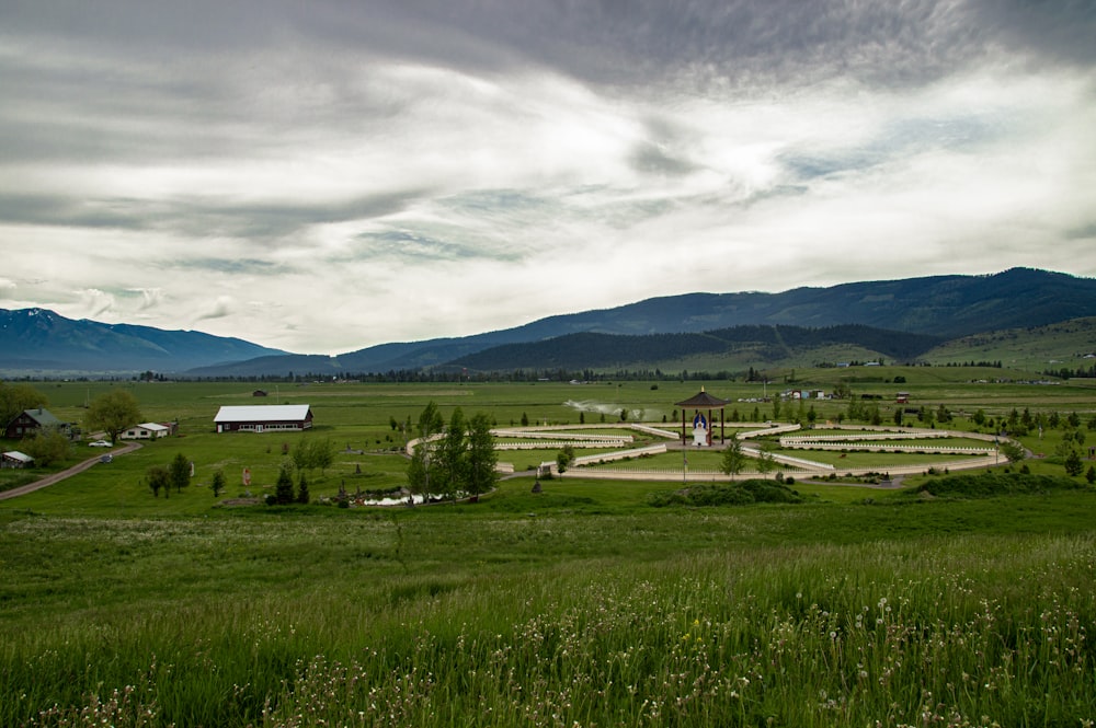 a large field with a circular structure in the middle of it